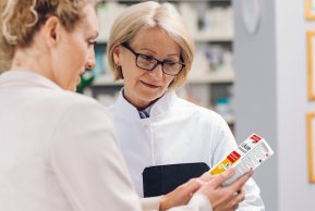 Produkt Zwei Apothekerinnen schauen sich ein mosquito Läuseshampoo 10 an